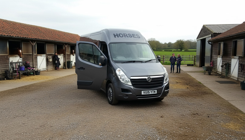 Silver horsebox at a stable yard